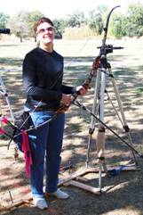 Photograph of Janice finishing a shooting end. She is holding her bow in a relaxed position, getting ready to step off the line.