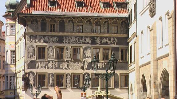 Sgraffito of Soldiers and horses. Backgroun is black. Figures are white.