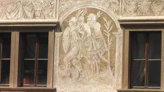 Sgraffito of 3 soldiers and a top border that looks like drapery
