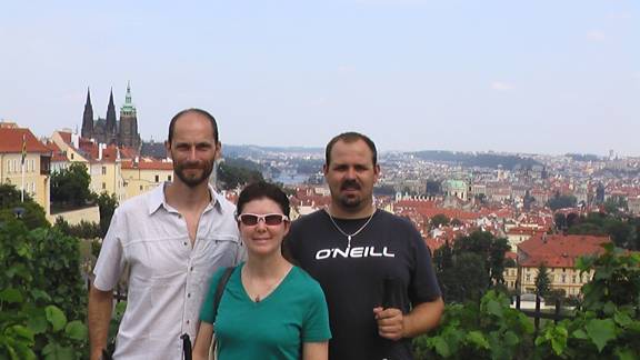 Paul, Janice and Ruben. View behind overlooks city of Prague.
